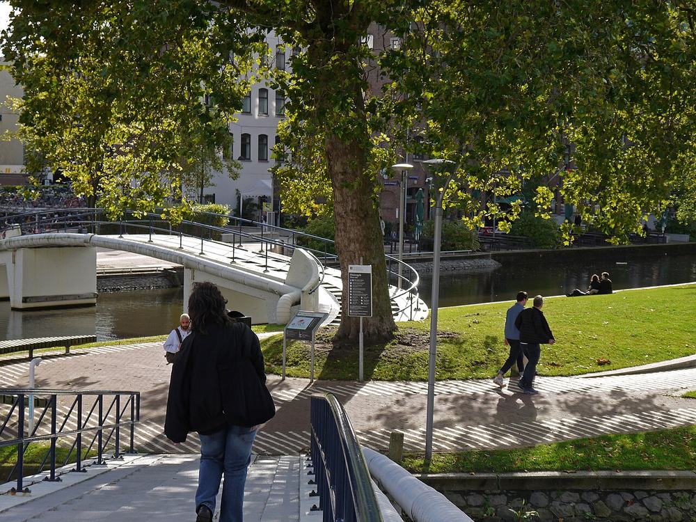 People walking over footbridges on the Roeterseiland university campus in Amsterdam